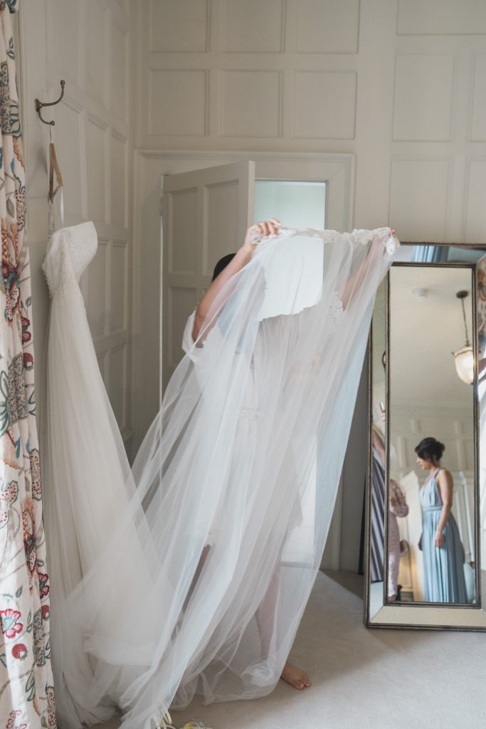 bridesmaid carrying veil Elmore court wedding photography