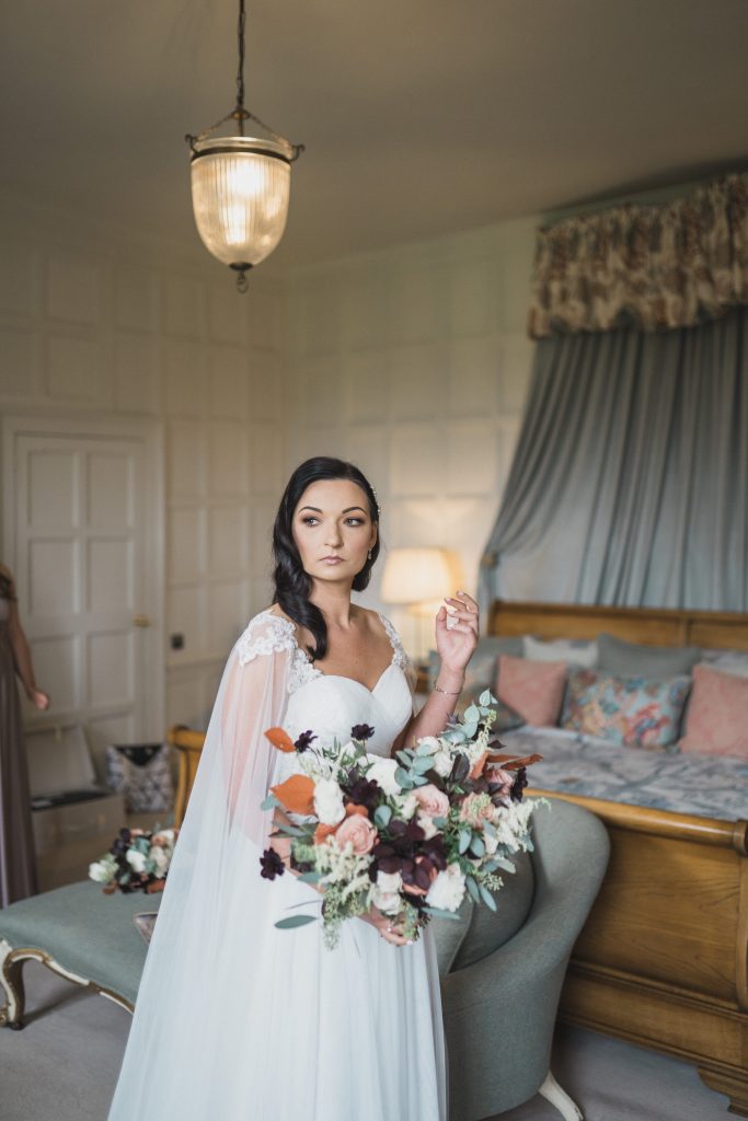 bride holding the rose shed wedding bouquet Elmore court wedding photographer