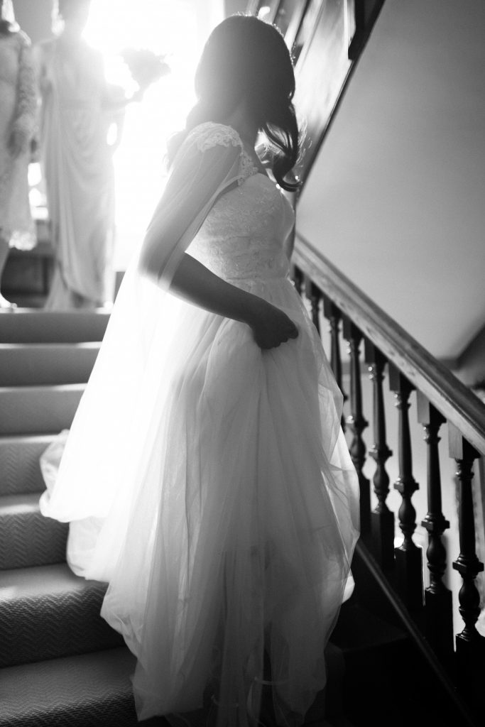 bride walking down staircase Elmore court wedding photography