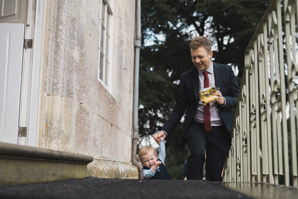 toddler walking up the stairs with dad Elmore court