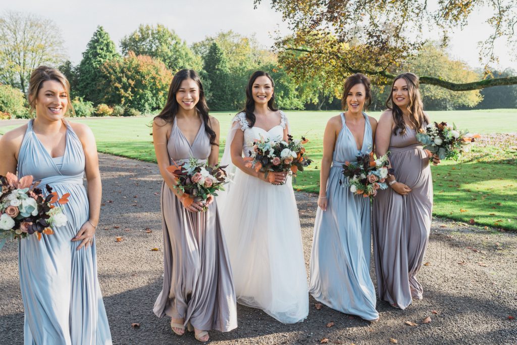 bride and bridesmaids walking at Elmore court wedding