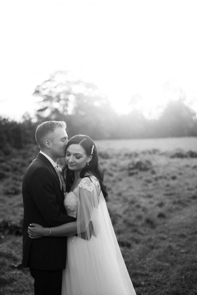 groom kissing bride Elmore court photographers