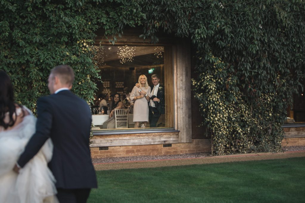 parents watching bride and groom Elmore court photographer