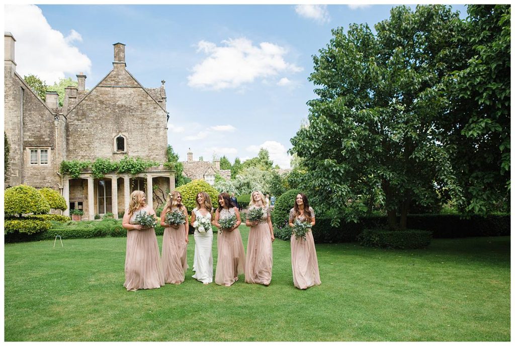 bridal party walking in gardens wedding photography