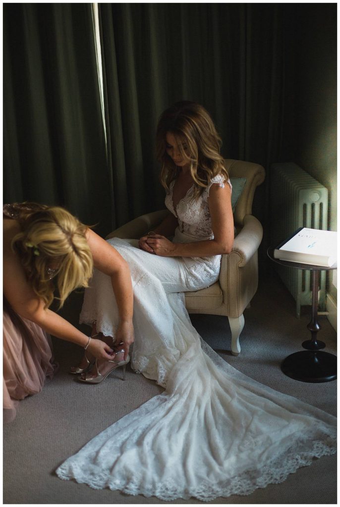 bride putting on jimmy choo shoes Barnsley house
